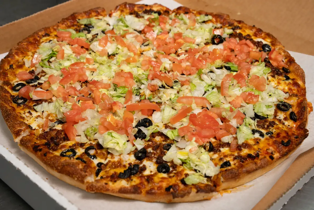 Taco pizza, sliced